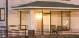 Image of the front porch of the Clinton Birthplace Home at night.